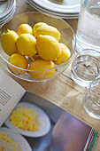 Bowl of lemons and recipe book on table in Smarden home Kent England UK