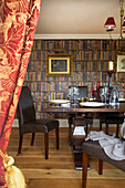 Dining room with trompe l'oeil bookcase in Smarden home Kent England UK