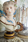 Vintage jewellery and female bust on marble dressing table in Kent home England UK
