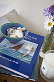 Seashells in bowl with scented candle and books in Dartmouth home, Devon, UK