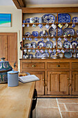 Blue and white chinaware on wooden kitchen dresser in kitchen of Etchingham farmhouse East Sussex England UK