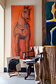 Large artwork canvas with wooden chair on landing in Etchingham farmhouse East Sussex England UK