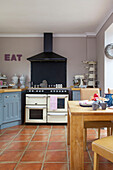 Range oven with terracotta tiled floor in Staplehurst kitchen Kent England UK