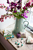 Cut flowers and notebooks on windowsill in Worth Matravers cottage Dorset England UK
