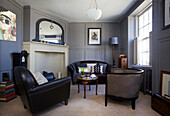 leather seating with wooden coffee table in living room of Old Town townhouse Portsmouth England UK