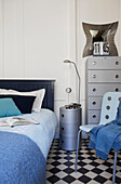 Light blue blanket on bed with silver metallic cabinet in Old Town bedroom Portsmouth England UK
