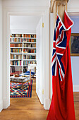 Red laundry bag with union jack and view through doorway to living room in Emsworth beach house Hampshire England UK