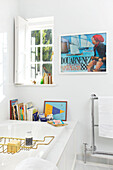 Vintage poster in white bathroom of Emsworth beach house Hampshire England UK