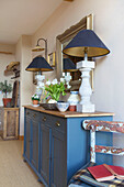 Blue matching lamps on painted sideboard in Kent farmhouse England UK