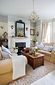 Two seater sofas with wooden coffee table in living room in Victorian villa Kent England UK