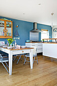 Open plan kitchen and dining room in Hayling Island beach house Hampshire England UK