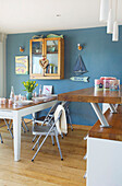 Wall mounted cabinet above table in kitchen of Hayling Island beach house Hampshire England UK