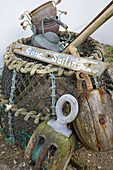Weathered lobster pot and sign reading 'Gone Sailing' at exterior of Hayling Island beach house Hampshire English UK