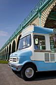 Ice cream van parked under wrought iron promenade in Brighton Sussex England UK