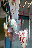 Heart shaped souvenirs on hooks in Brighton Sussex England UK