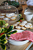 Mince pies on cake stand with gingham dishcloth on Faversham kitchen table Kent England UK