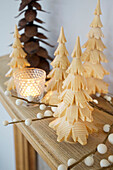 Carved wooden Christmas trees with lit candles in Faversham home Kent England UK