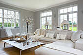 White corner sofa with low coffee table in living room of Faversham home Kent England UK