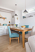 Light blue chairs at table in Dartmouth kitchen Devon UK