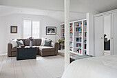 Beige corner sofa in spacious all white Southsea bedroom UK