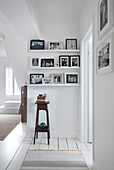 Framed family photos on shelving with Victorian plantstand Southsea UK