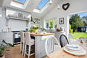 Pale grey open plan kitchen diner with view through to the garden Oxfordshire UK