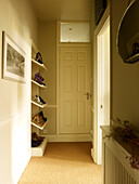Shoe storage in hallway of Kensington home London England UK
