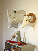 Wall mounted animals head above bookcase with toys in childs room of London home England UK