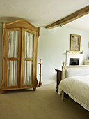 Wooden wardrobe and candle holder in bedroom of Nottinghamshire home England UK
