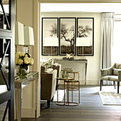 Triptych with brass nested tables in living room of London townhouse, UK