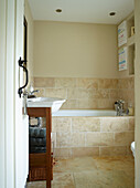 Wooden washstand in tiled bathroom of Oxfordshire cottage, England, UK