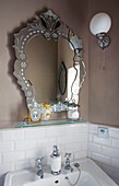 Mirror and glass shelf with wash basin in Hove home East Sussex UK