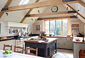 Pitched timber framed kitchen conversion in roof space of Kent country cottage, England, UK