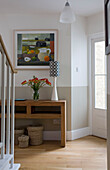 Artwork above console table in hallway of Cambridgeshire home UK
