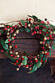 Christmas wreath hangs above fireplace in Kent home, England, UK