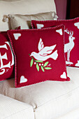 Red and white festive cushion on a sofa in Kent home, England, UK
