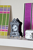 Carriage clock with artwork on shelf in contemporary London home, UK