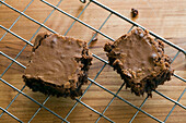 Two chocolate brownies on a cooling tray in a London home, England, UK
