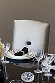 Place setting on black dining table in Hendon home London UK