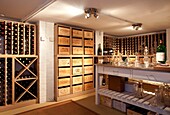 Crates and bottles in wine cellar of Epsom home Surrey UK