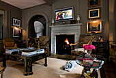 Dog sleeps at fireside of Epsom living room with oversized bust Surrey UK