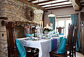Turquoise cushions on dining chairs in Cotswolds home UK