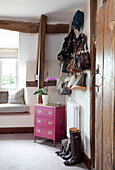 View through doorway to living room with bags in timber framed Cotswolds cottage UK