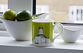 Fruitbowl and cup on London windowsill UK