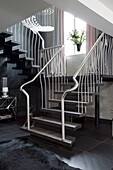 Metal handrail on open tread staircase in contemporary London townhouse, UK