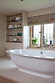 Freestanding bath at window in Cotswolds home