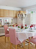 Red and white decorated festive dining room with decorative screen and candelabra