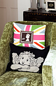 Union Jack cushion and cushion with angel ion armchair in Sussex farmhouse, UK