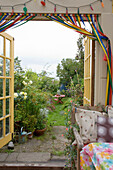View through open double doors to garden of Rye home, East Sussex, England, UK