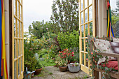 View through open double doors to garden of Rye home, East Sussex, England, UK